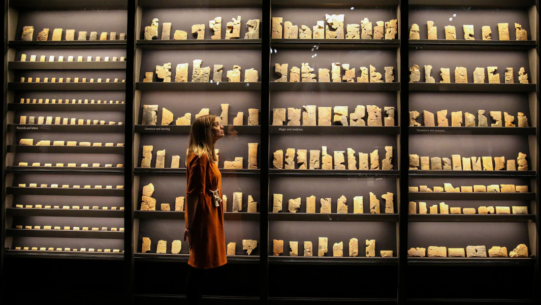 Woman standing in front of ancient texts