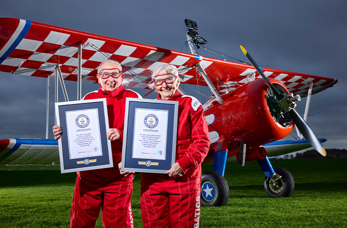 the oldest wing walkers in front of a plane