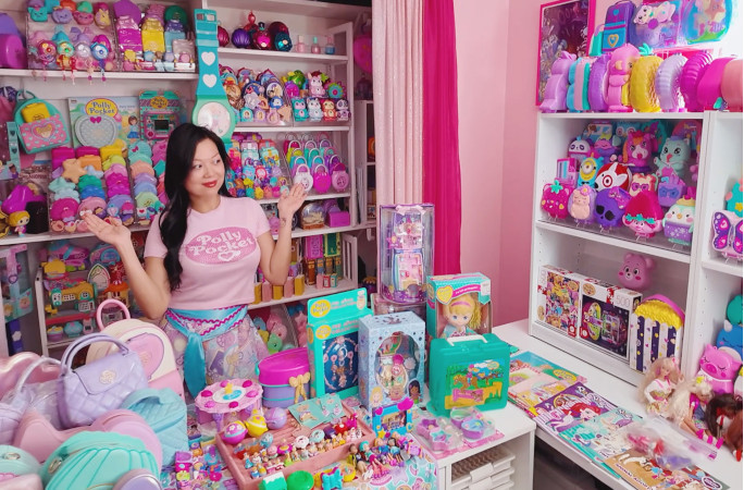 Kerchie shrugging in front of her collection