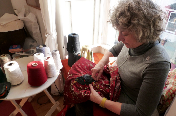 Welsh embroiderer working on dress
