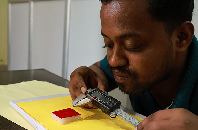 artist measuring the spoon