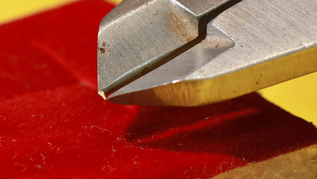 split image of artist working on the smallest wooden spoon and it up close