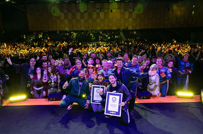 on stage with fans in cosplay