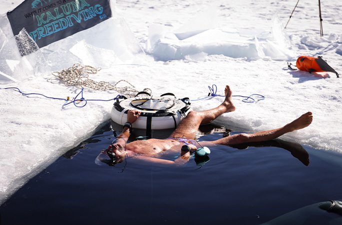 diver lying on his back in the water