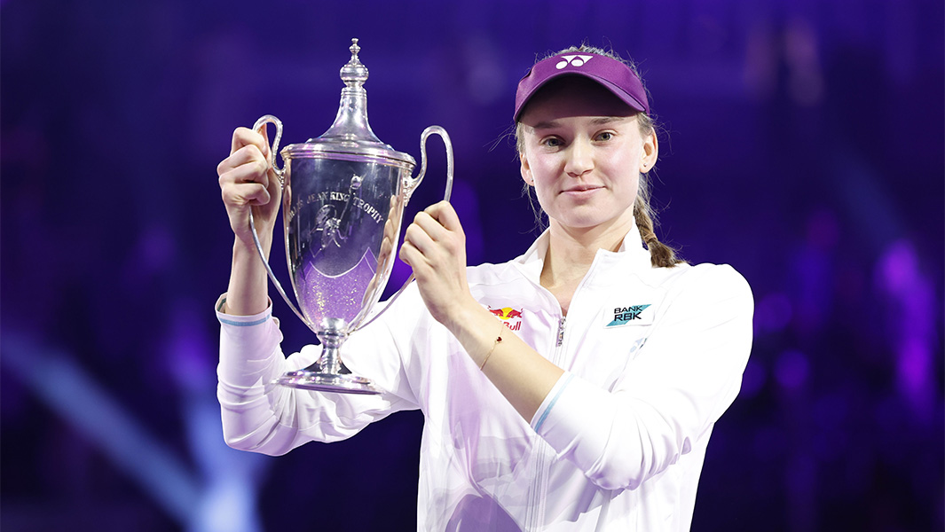 Elena Rybakina holding up her WTA trophy