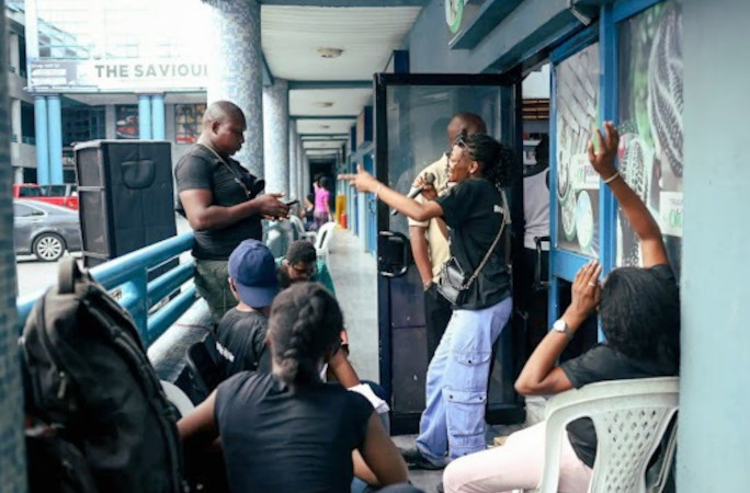 Friends singing outside Mary's shop