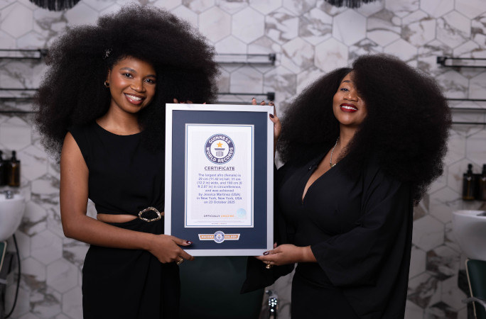 Aevin and Jess holding their certificate