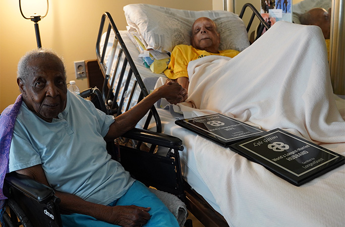 Lyle in bed and Eleanor sitting next to him