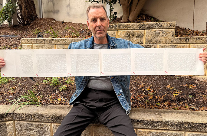 Laurence holding up his name