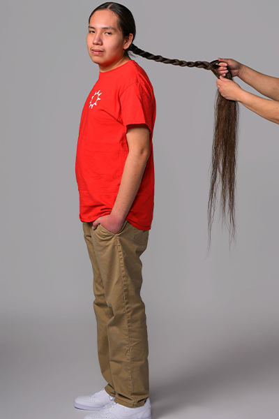 Reuben having his hair braided
