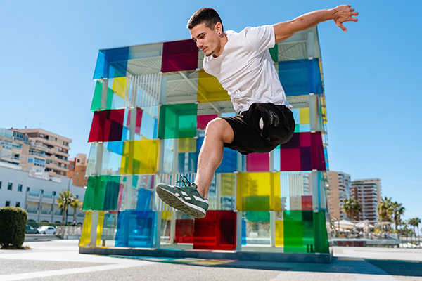 ruben jumping with colors in the background