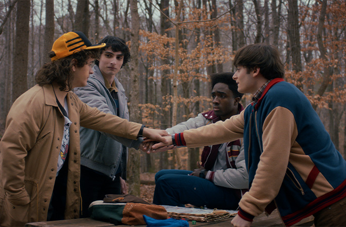 the Stranger Things boys in the woods doing 'hands in'