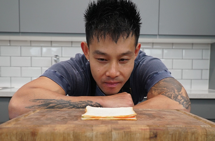 Wallace inspecting his sandwich