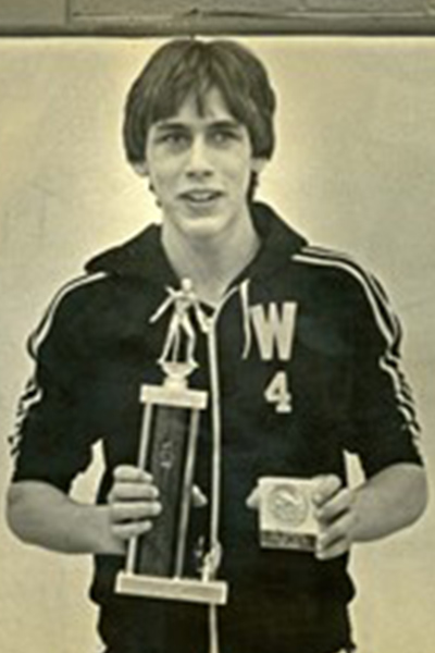 erik-in-his-teens-with-one-of-his-high-school-wrestling-trophies