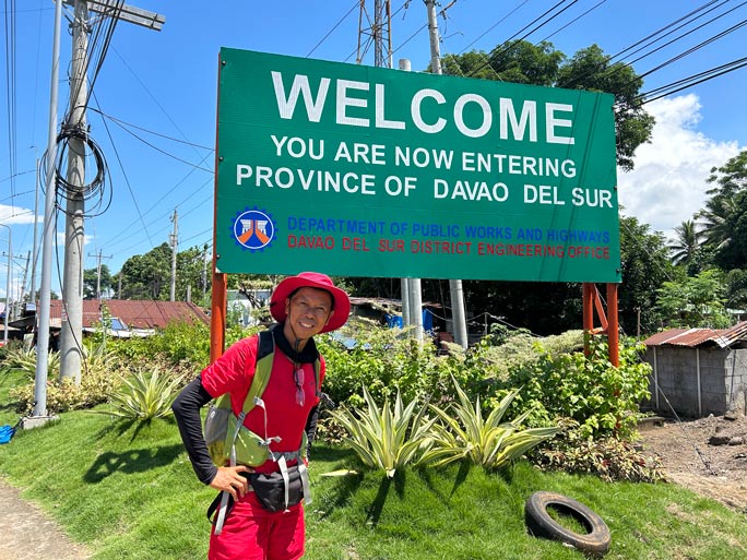 Lito in front of signage of Davao del Sur
