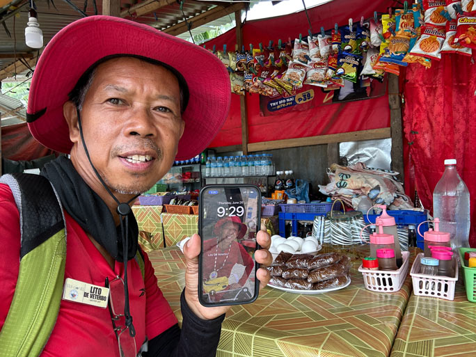 Lito holding out a phone