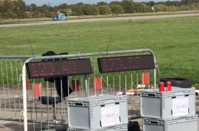 Car racing in front of the timers