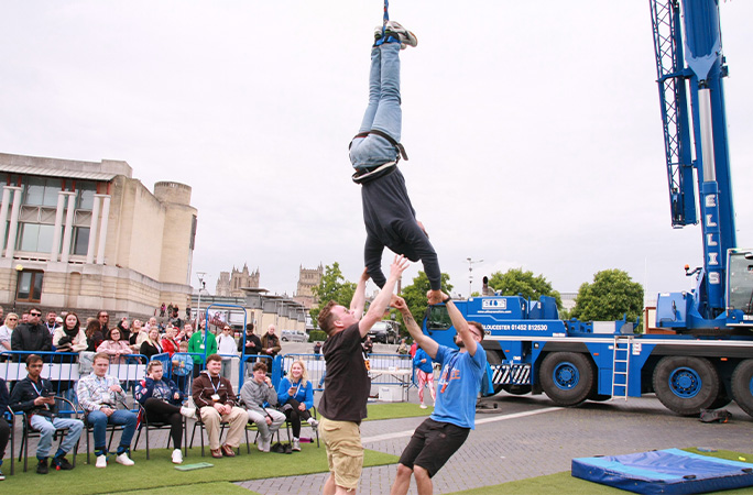 record holder being grabbed by two men at bottom of a bungee jump