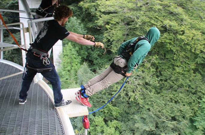 record holder leaning forward into bungee jump