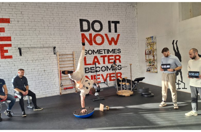 Marius completing the record for longest duration to perform a single arm handstand on a balance dome (male).