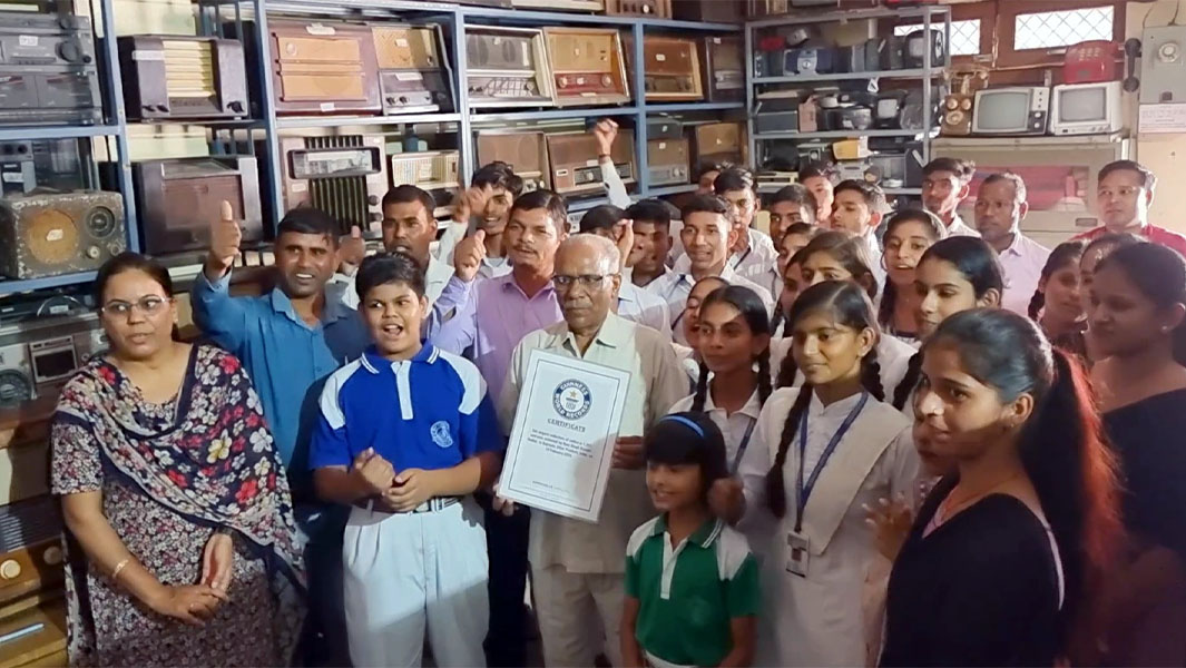 Ram poses with his certificate and a group of friends and family