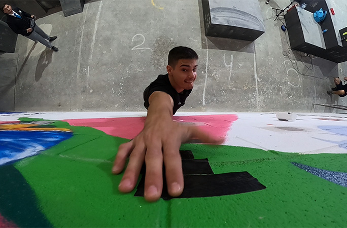 Ruben jumping up to touch a piece of tape on a wall