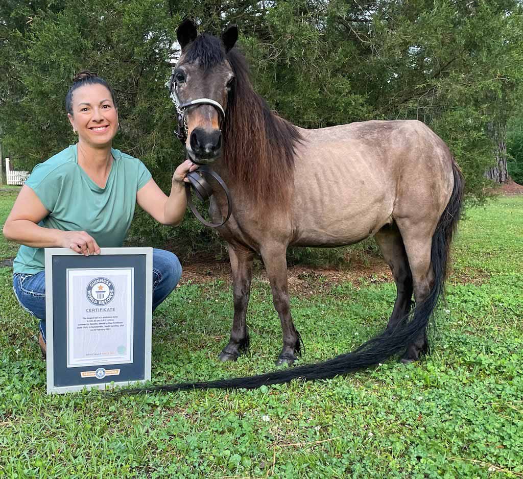 Sweetie with her certificate and owner