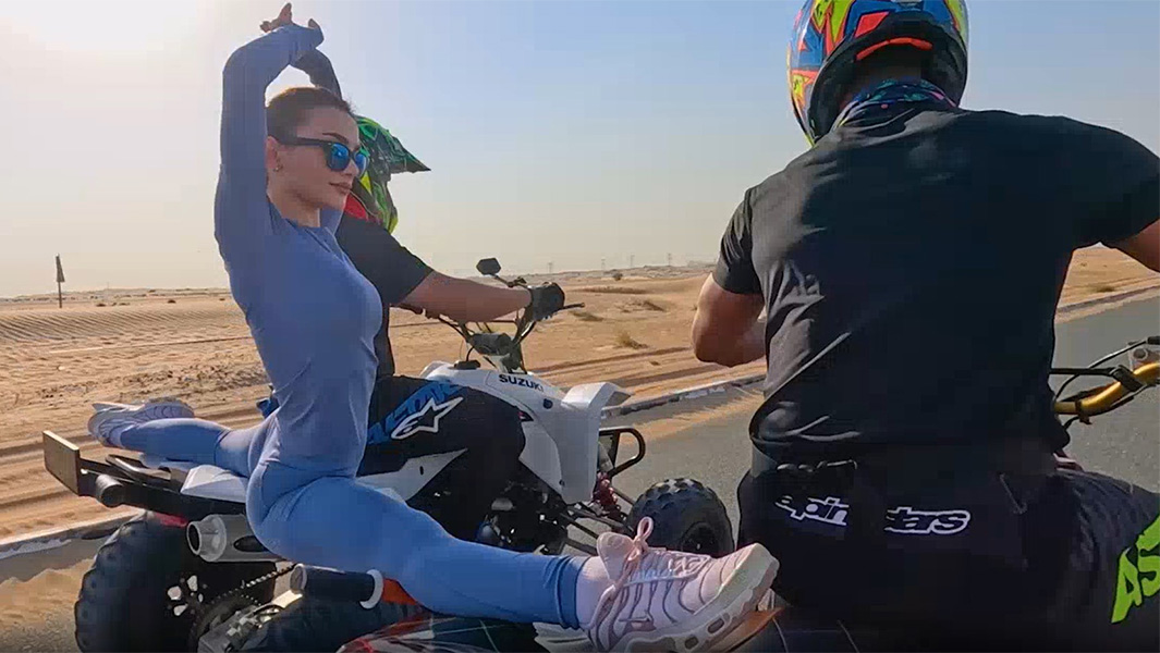 Yara performing the splits across two moving ATVs