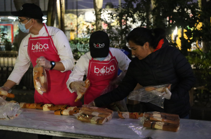 Close up on workers assembling breads