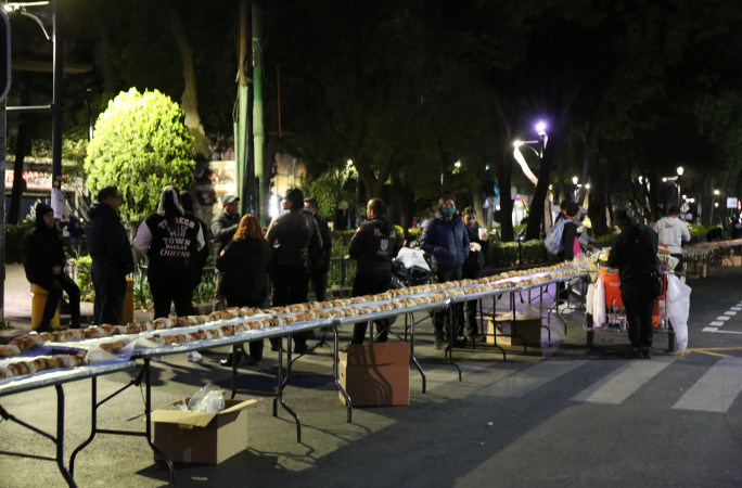 People selecting their breads from the line