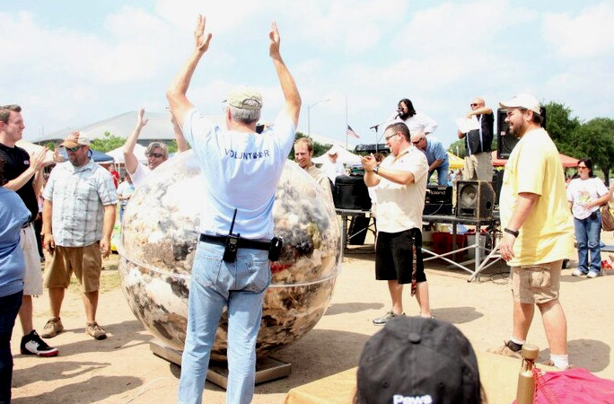 Volunteers celebrate with their dogs after filling their bowl with dog hair