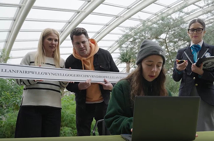 Woman typing while adjudicator and others watch