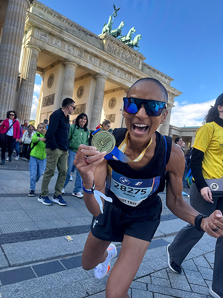 Adele smiling and showing her medal