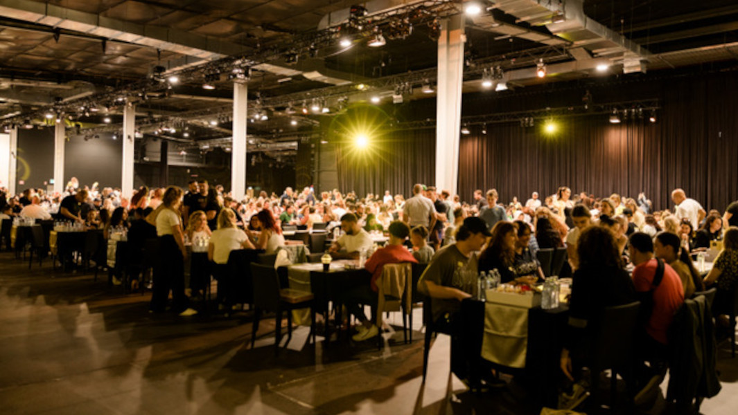 Tables of people gathered to play Monopoly