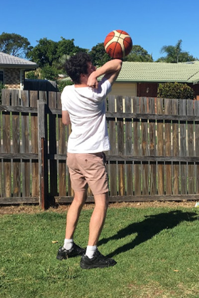 Brendan spinning a basketball on his elbow