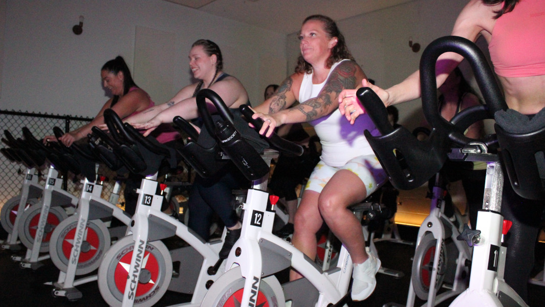 Heather MacDonald (in white) cycling in her spin class