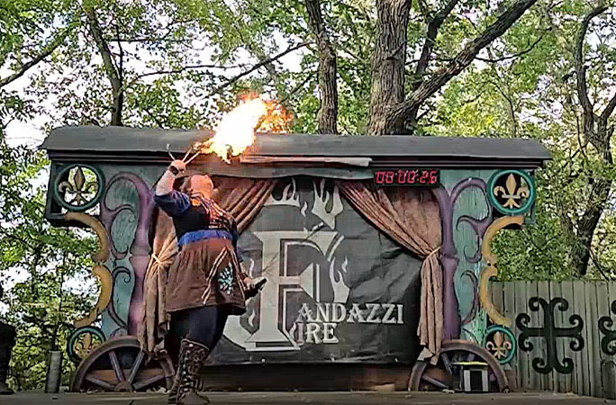 Raederle breathing fire on stage