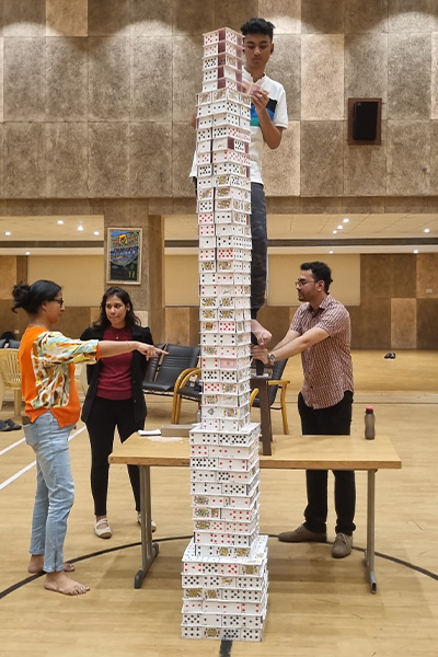 Arnav building his card tower
