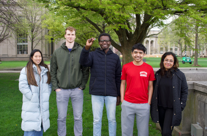 Tobi smiling with his friends from MIT