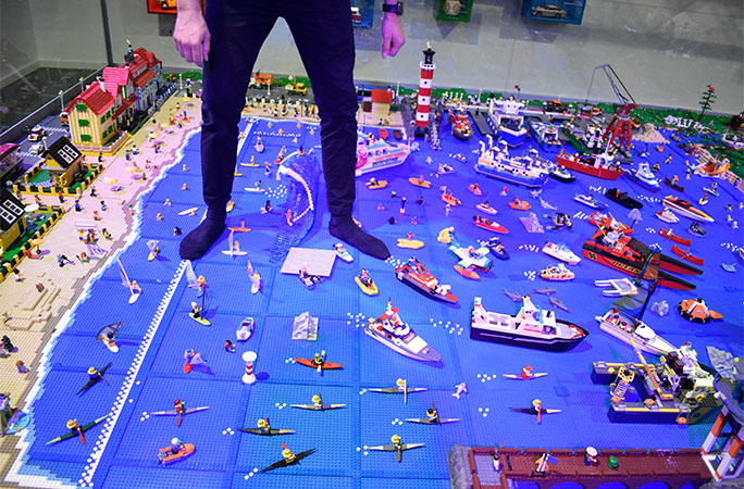 man standing in the sea of the LEGO diorama