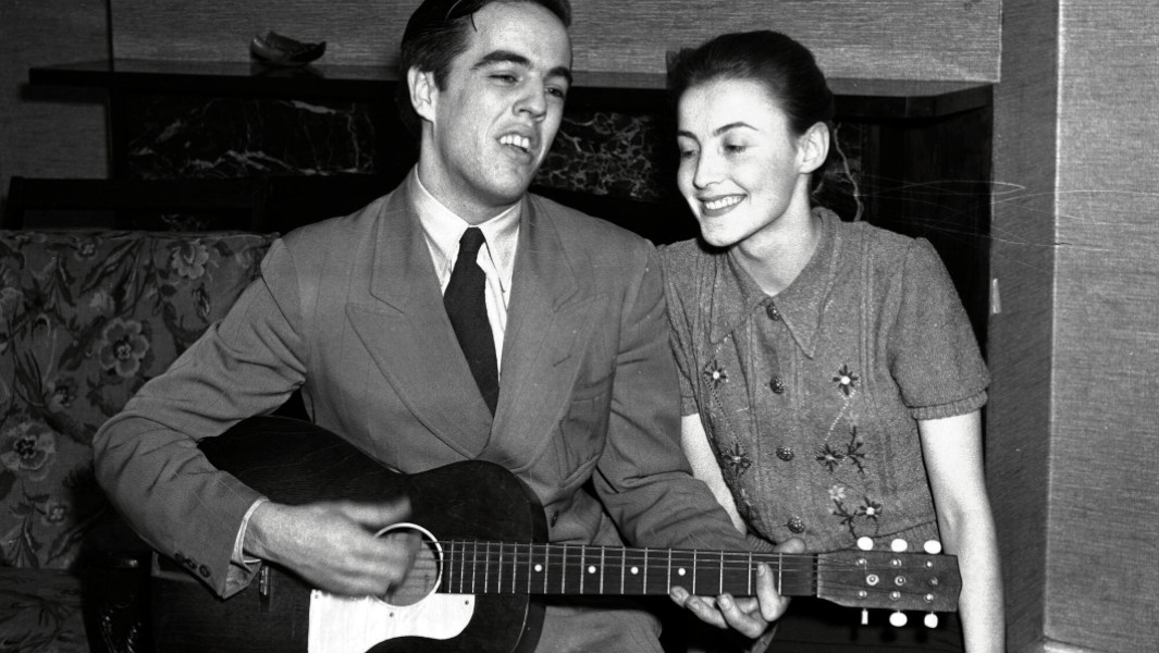 Alan Lomax playing guitar with his wife