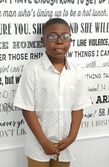 Caleb standing in front of wall