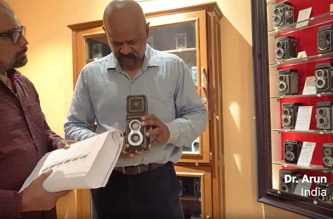 Dr Arun holding a camera