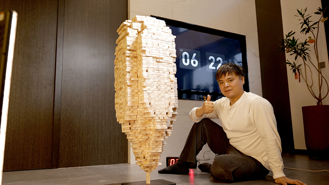 tianrui-sitting-next-to-jenga-tower-thumb-up