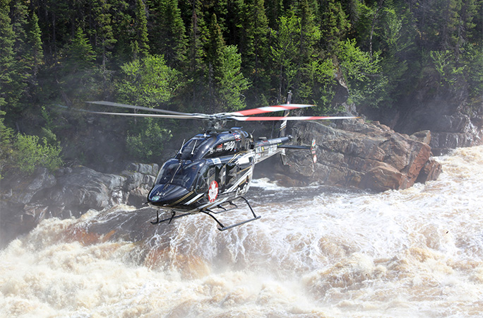 helicopter flying over rapids