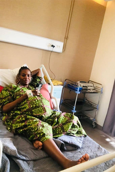 Pregnant Halima sitting in a hospital bed