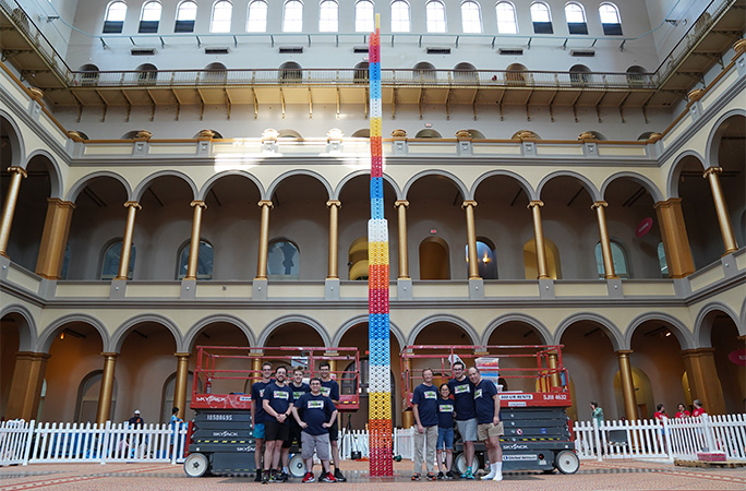 wider angle of the team in front of the tower