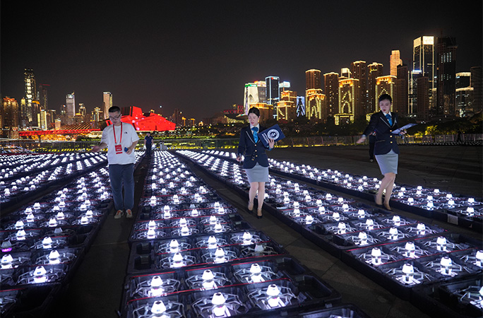 adjudicators standing amongst drones lined up on the ground