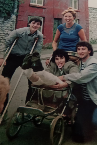 Liam being pushed in a pram after his accident