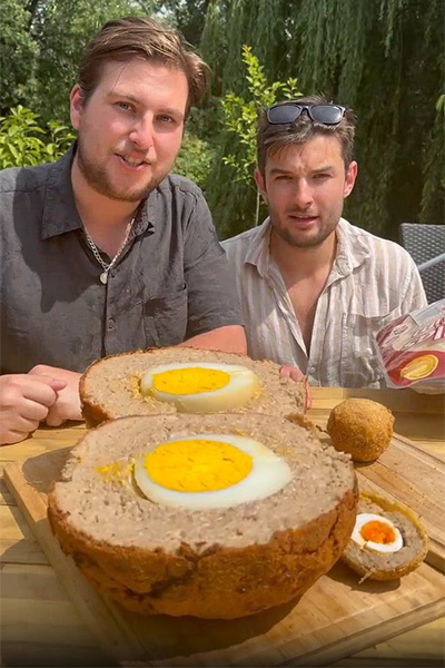 largest scotch egg next to a regular one